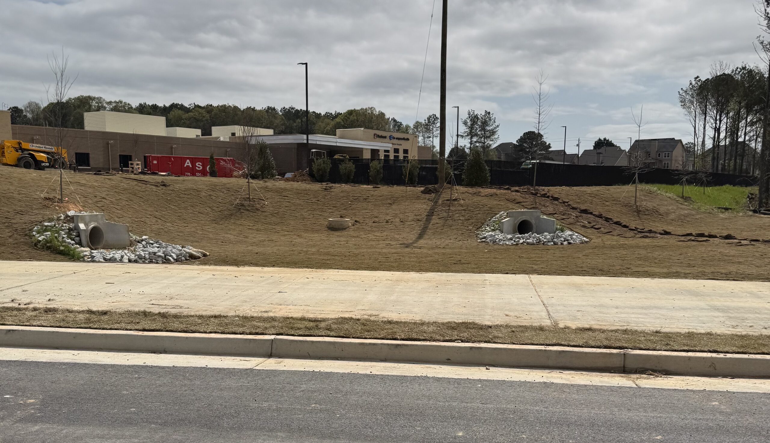 Piedmont Encompass Health Eastside Rehabilitation Hospital under construction — view from Loganville Highway showing the Piedmont and Encompass Health signage on the building facade, Loganville GA 2026